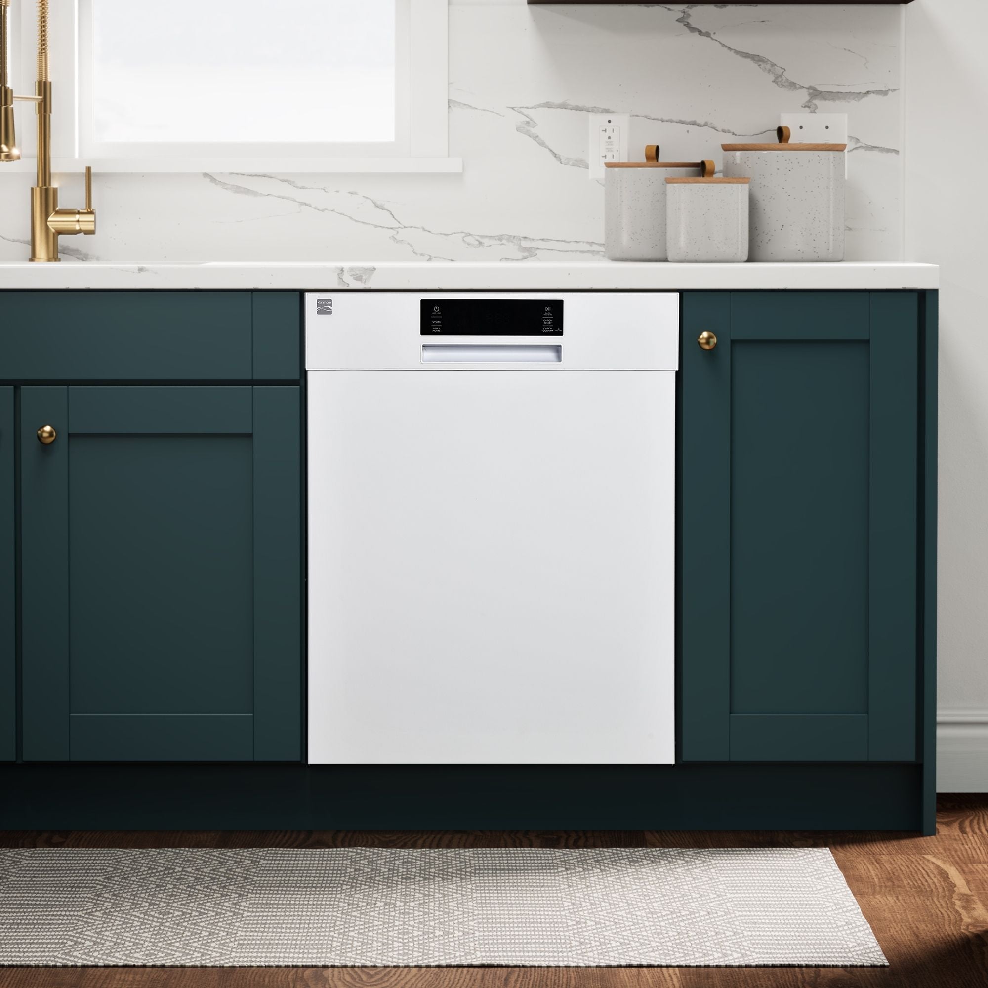 Kenmore white dishwasher installed in a bright kitchen with dark green cabinets