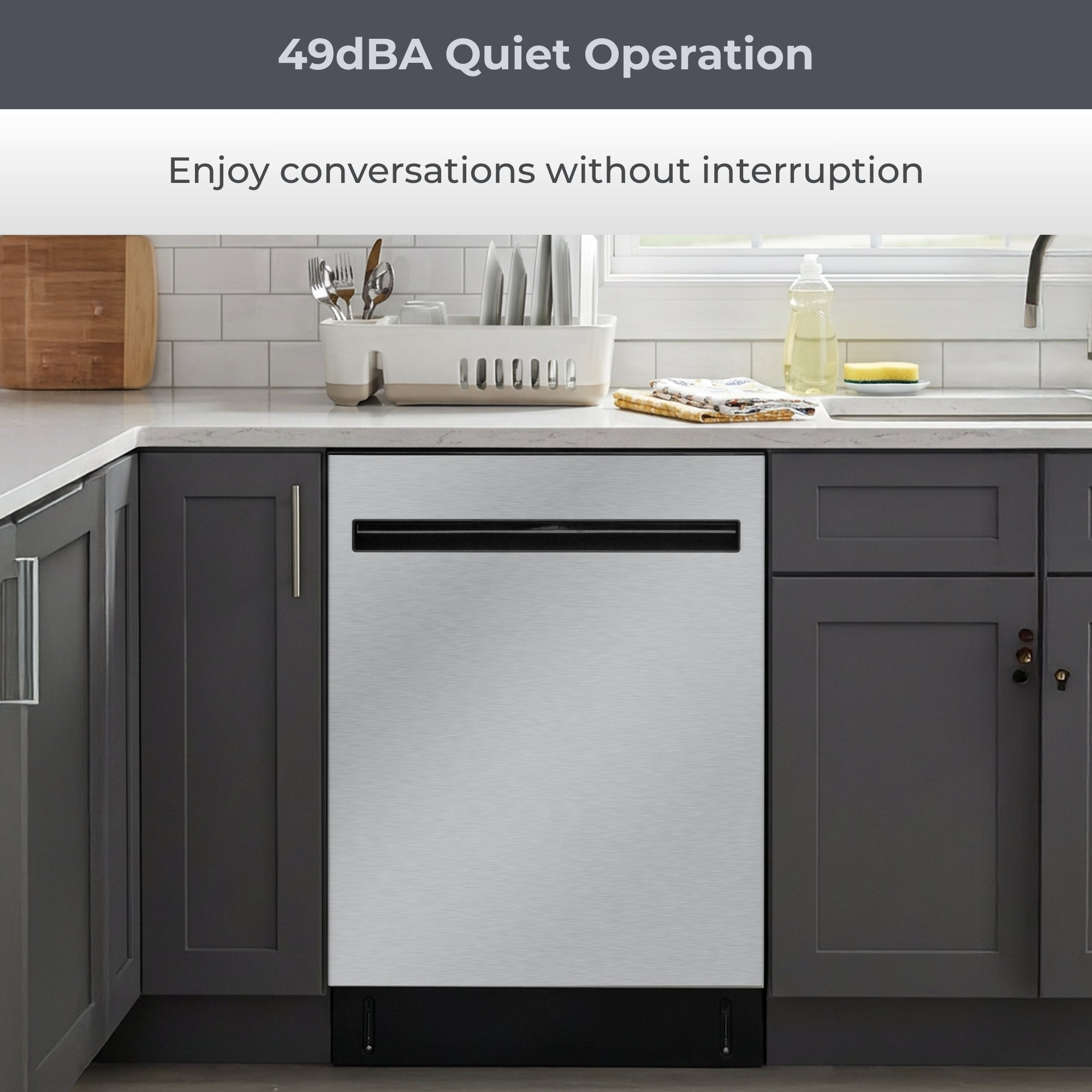 Kenmore ultra-quiet 24-inch top control dishwasher installed in a bright kitchen with grey cabinets. Text above reads, “49 dBA quiet operation: Enjoy conversations without interruption”