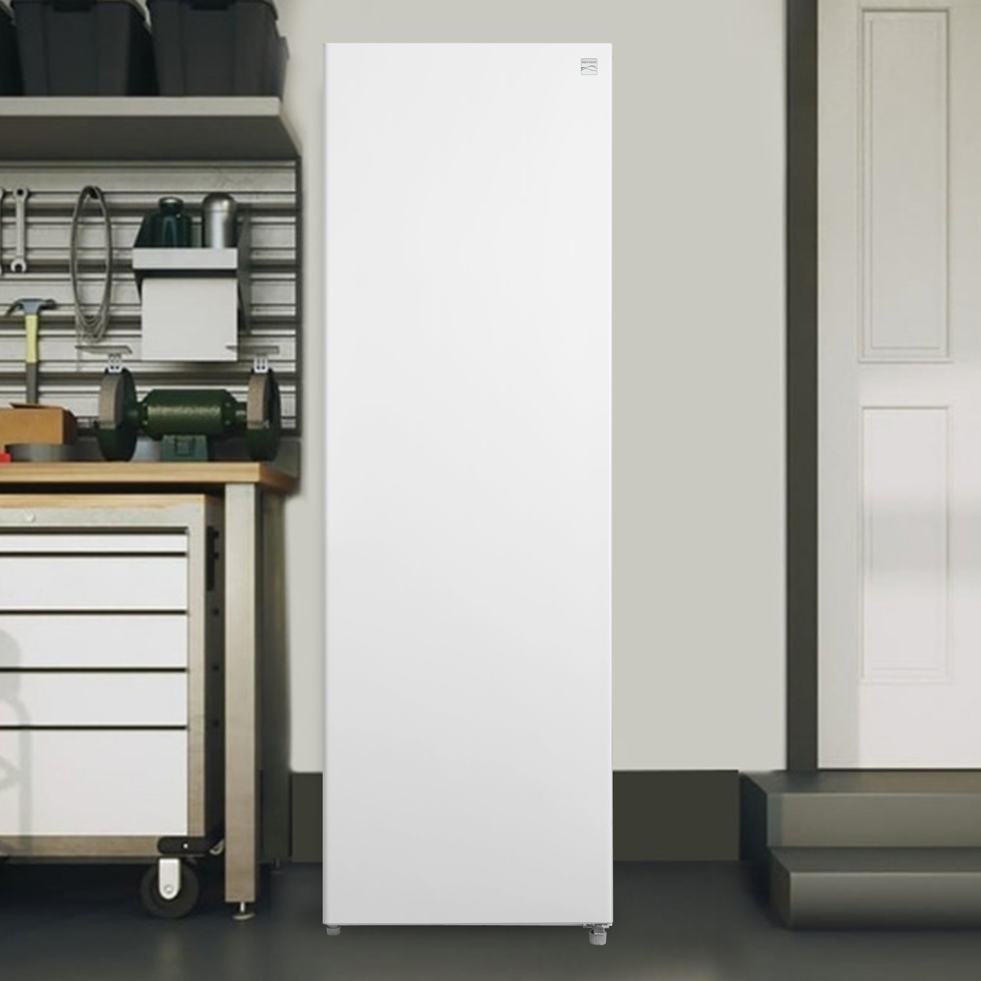 Kenmore convertible upright freezer/refrigerator in a bright clean garage with a tool bench to the left and a door to the right
