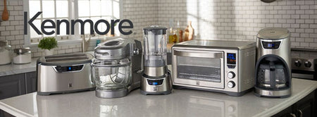 Lifestyle image of Kenmore Elite products - long-slot toaster, gray Ovation mixer, stand blender, convection oven, and coffee maker - on a light gray kitchen counter.