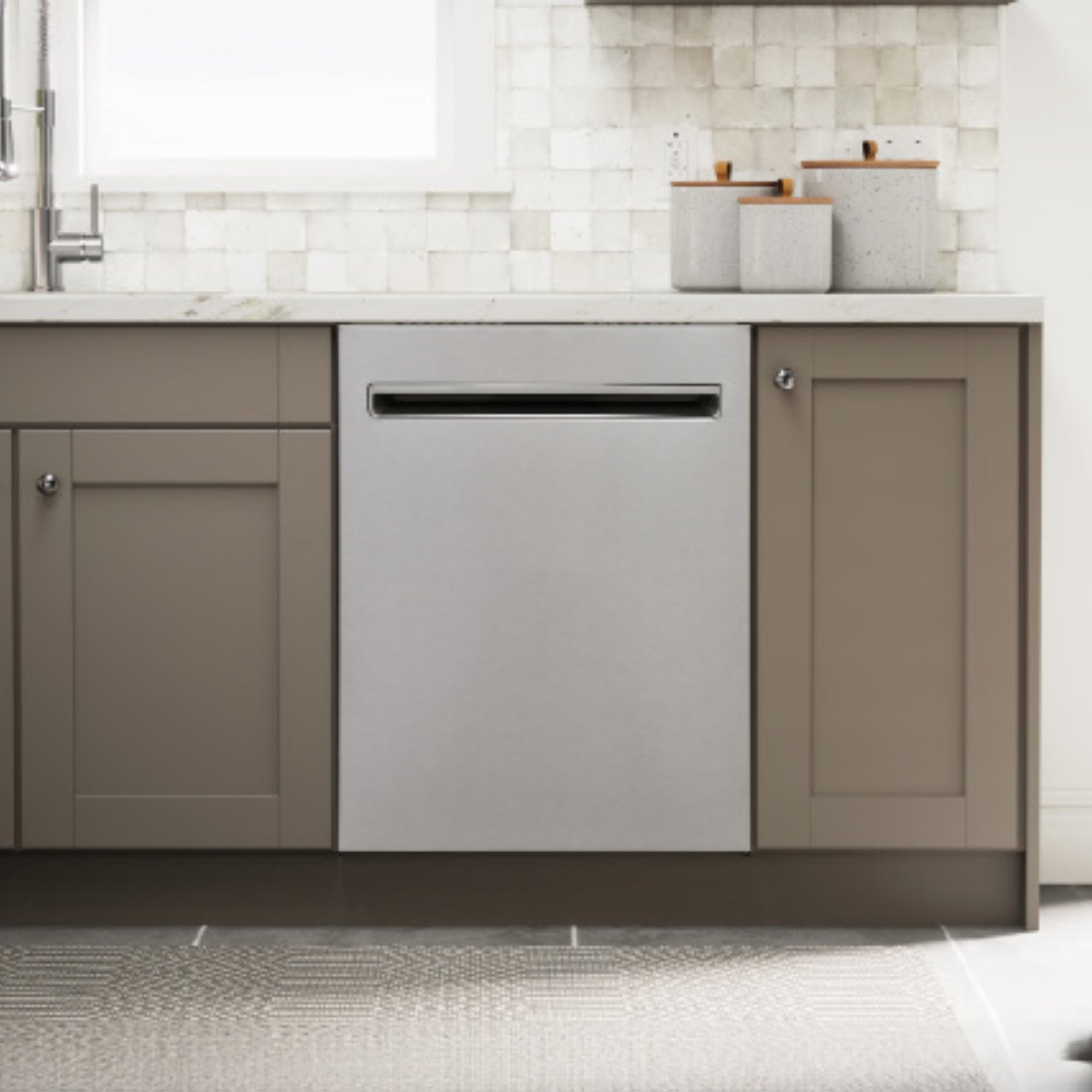 Kenmore stainless steel dishwasher installed in a bright kitchen with light brown cabinets