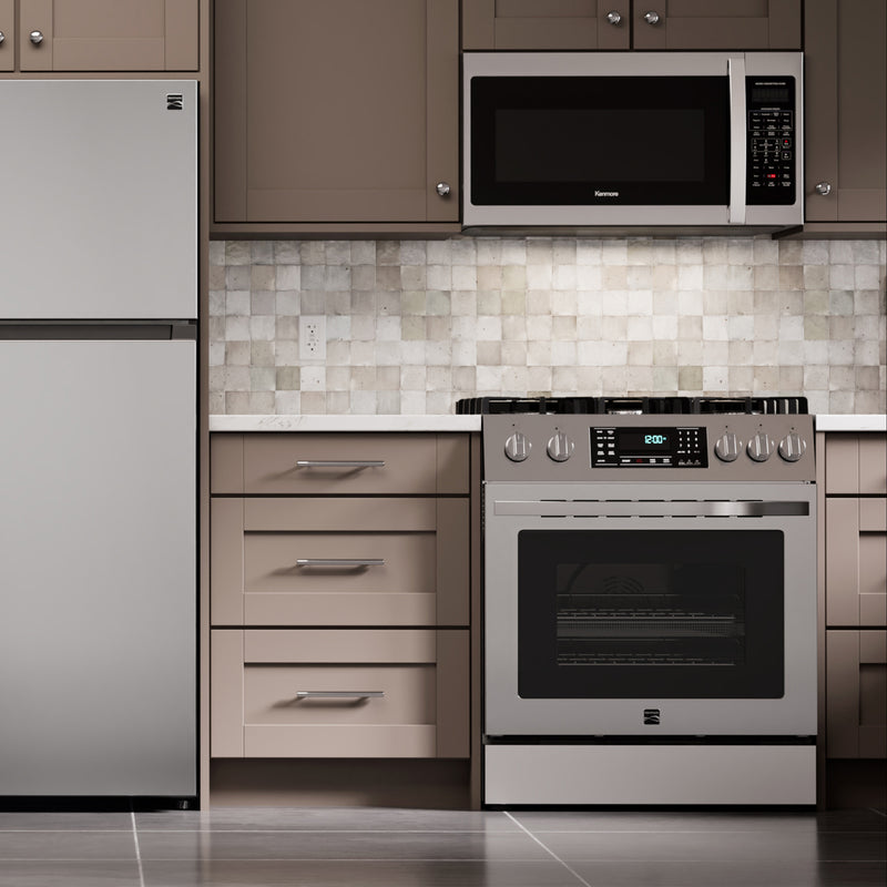 Kenmore stainless steel gas range installed in a light gray and beige kitchen