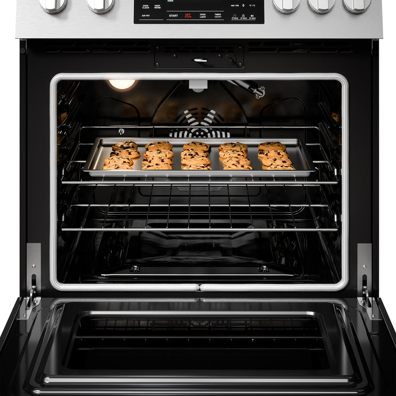 Closeup of the interior of the Kenmore stainless steel gas range with a tray of cookies inside