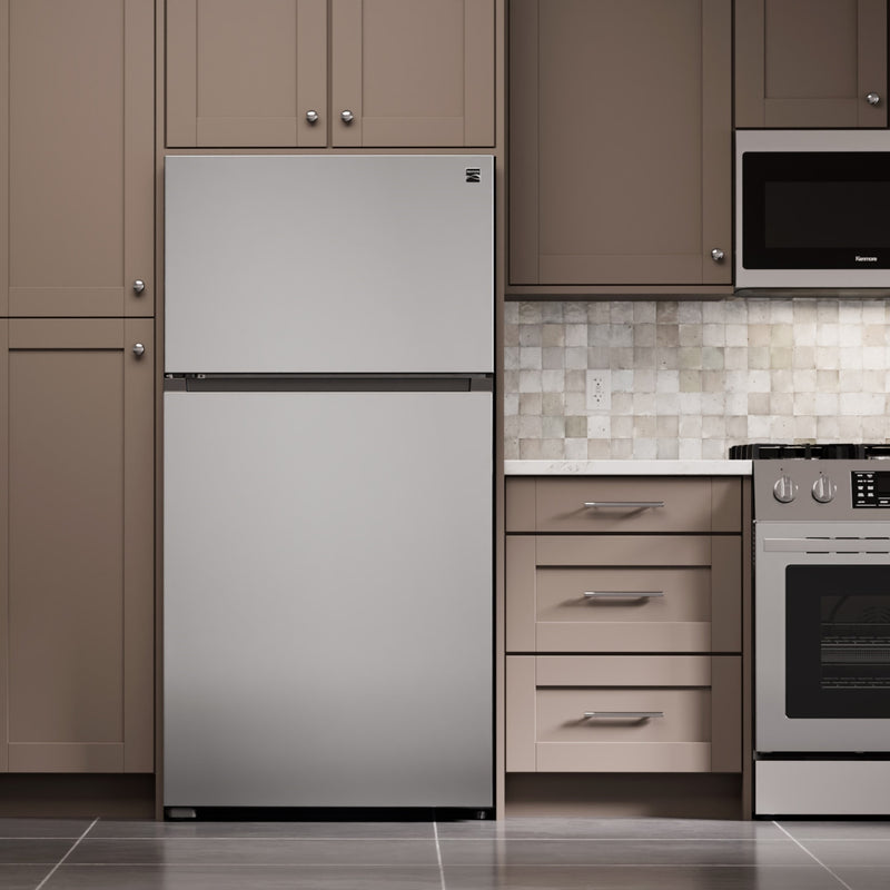 Kenmore stainless steel top mount refrigerator in a light gray and beige kitchen