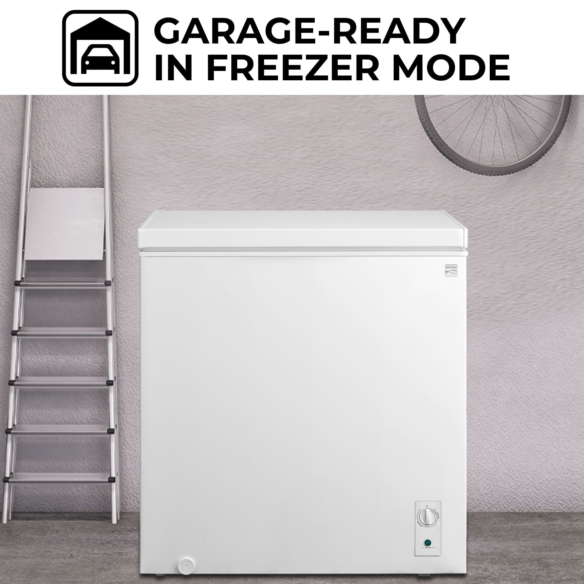 Kenmore convertible freezer/refrigerator, closed, in a garage with a light gray wall behind, metal ladder to the left and bike hanging above. Text above reads, "Garage-ready in freezer mode"