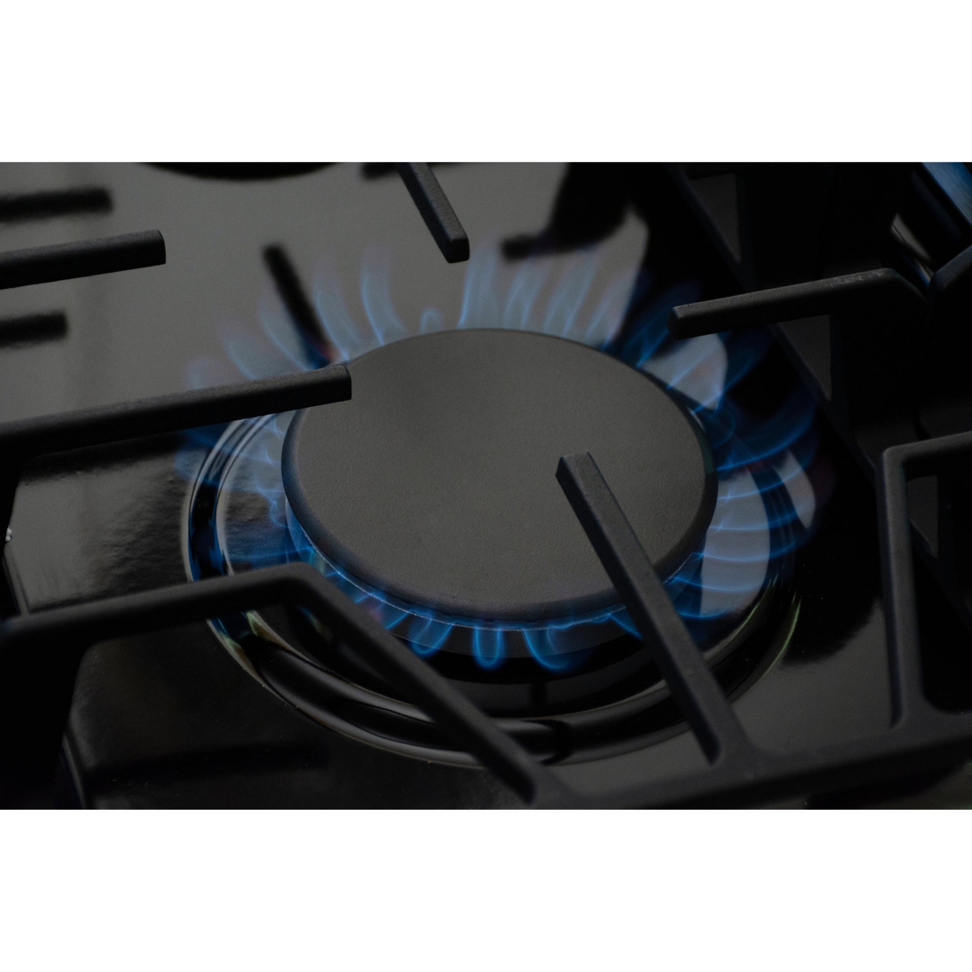 Closeup view of the Kenmore PRO stainless steel front-control range showing a lit gas burner with a blue flame