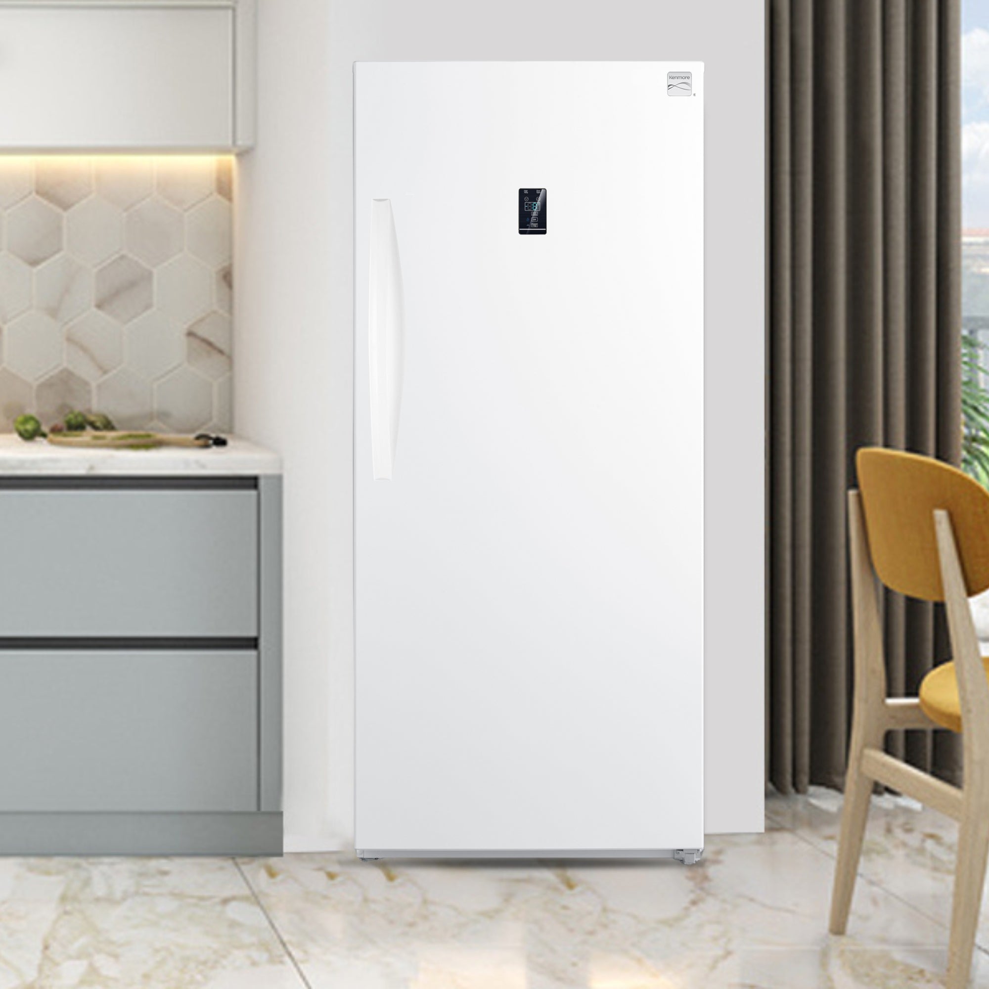 Kenmore convertible upright freezer/refrigerator in a bright clean kitchen with light gray cabinets to the left and a window and chair partly visible to the right