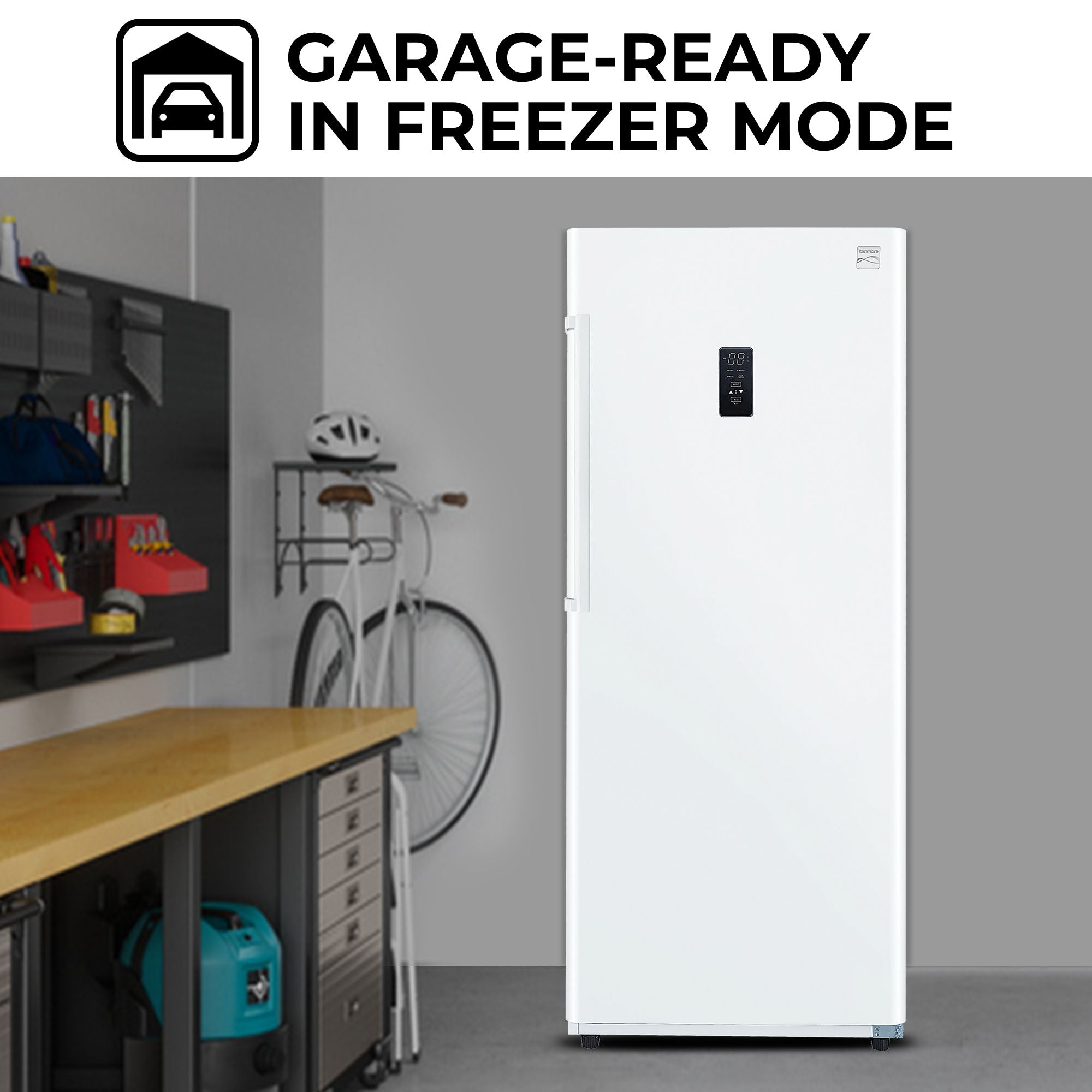 Kenmore convertible upright freezer/refrigerator, closed, in a garage with a gray wall behind and bicycle and helmet and tool bench to the left. Text above reads, "Garage-ready in freezer mode"