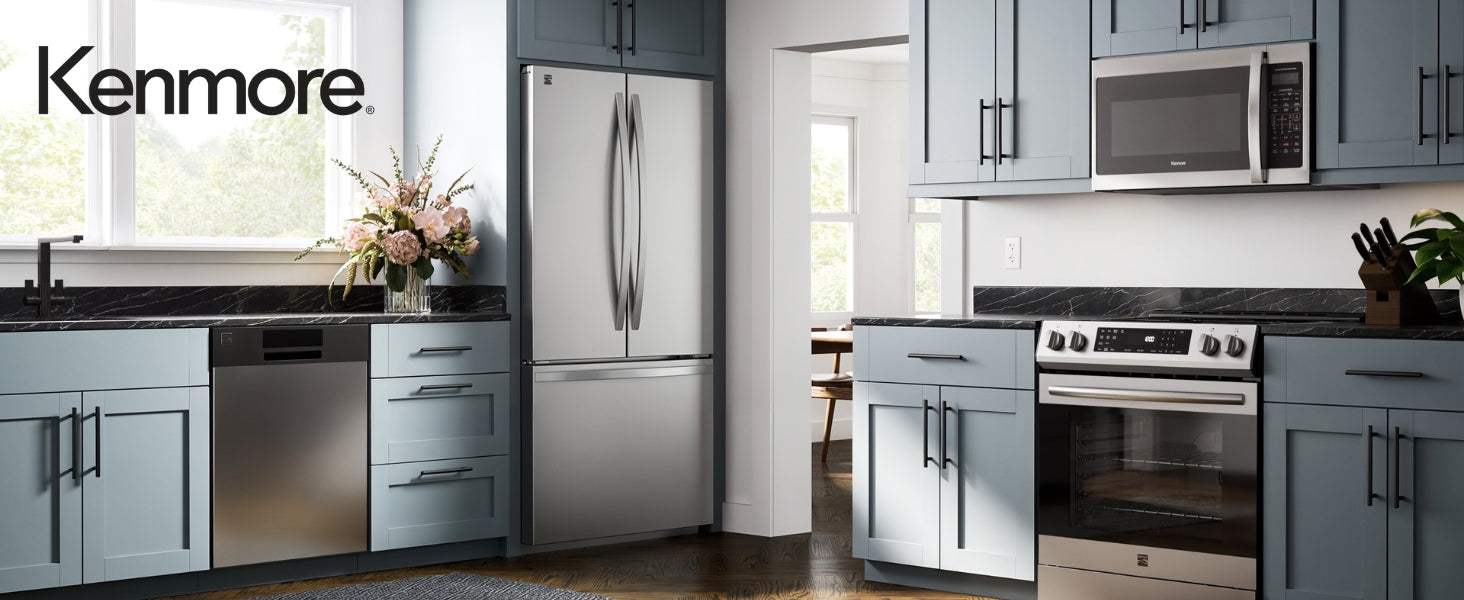 Kenmore over-the-range microwave installed in a bright modern kitchen with a stainless steel range and light blue cupboards.