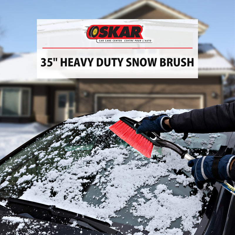 Lifestyle image of a gloved hand using the snow brush to remove snow from the windshield of a dark coloured car. Transparent white overlay at the bottom shows the Oskar logo above text reading "35" heavy duty snow brush"
