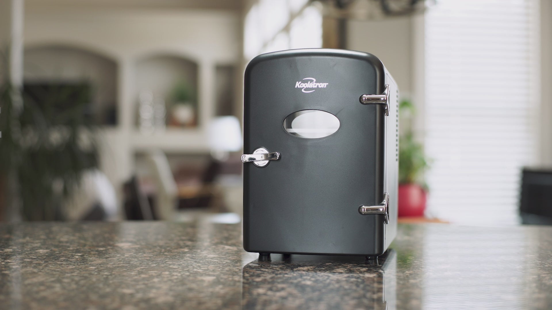 Video with music playing in the background shows the parts and features of the Koolatron retro portable 12V mini fridge