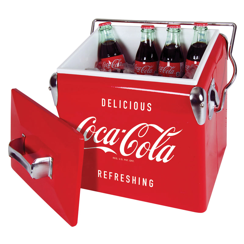Product shot of Coca-Cola retro ice chest with bottle opener, open with bottles of Coke inside and lid leaning against the cooler, on a white background