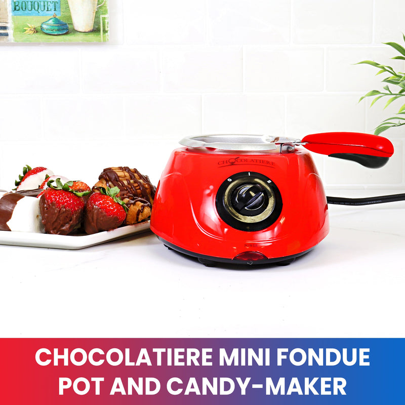 Lifestyle image of electric chocolate melter on a white counter with a plate of chocolate dipped strawberries and marshmallows to the left. Text below reads, "Chocolatiere mini fondue pot and candy-maker"