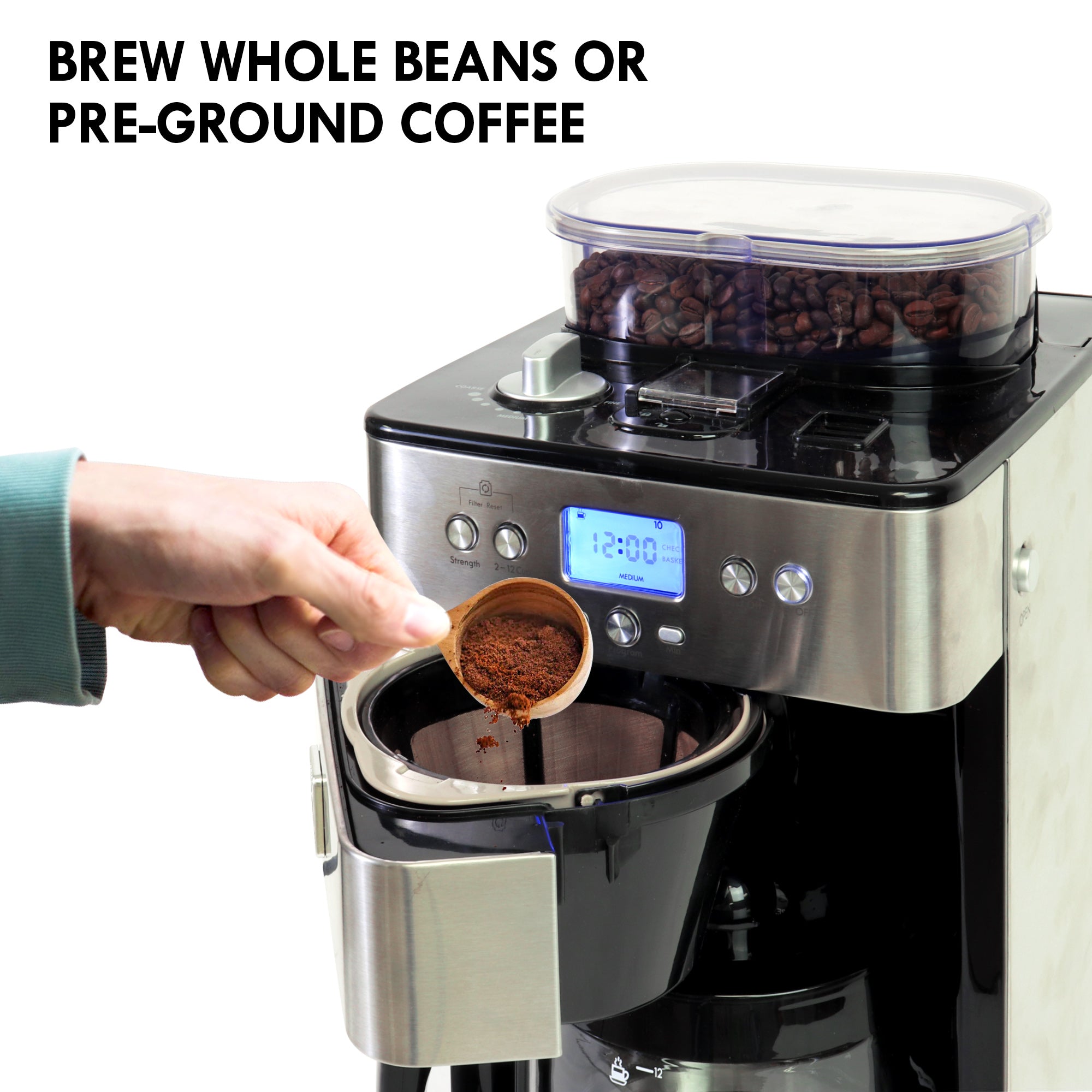 Kenmore grind and brew coffee maker with whole coffee beans in the hopper and the coffee filter compartment open on a white background. A person's hand is visible pouring ground coffee from a measuring scoop into the reusable filter. Text above reads, "Brew whole beans or pre-ground coffee"