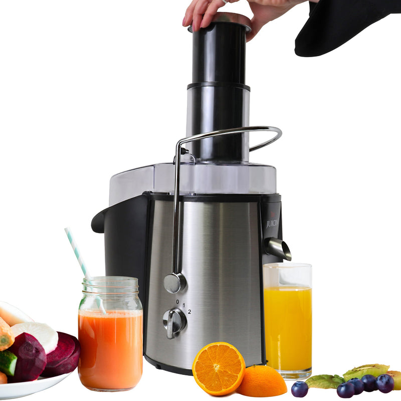 Product shot of juicer surrounded by fruits and vegetables and glasses of juice on white background