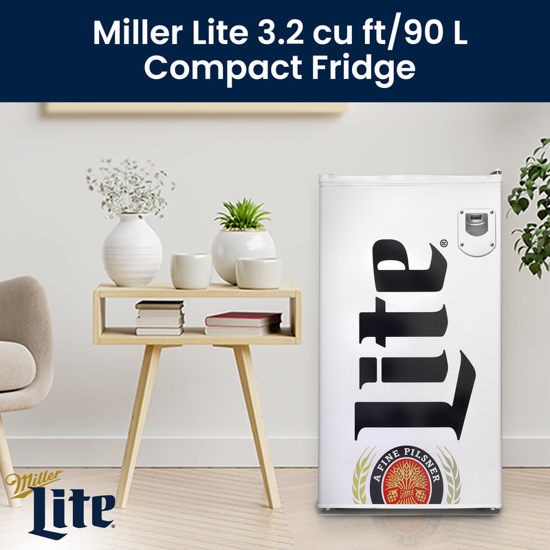 Lifestyle image of Miller Lite compact fridge, closed, on a light-colored wood floor with a white painted wall behind and a minimalist maple side table to the left with books and white ceramic pots with plants on it. Text above reads, "Miller Lite 3.2 cu ft/90L compact fridge"