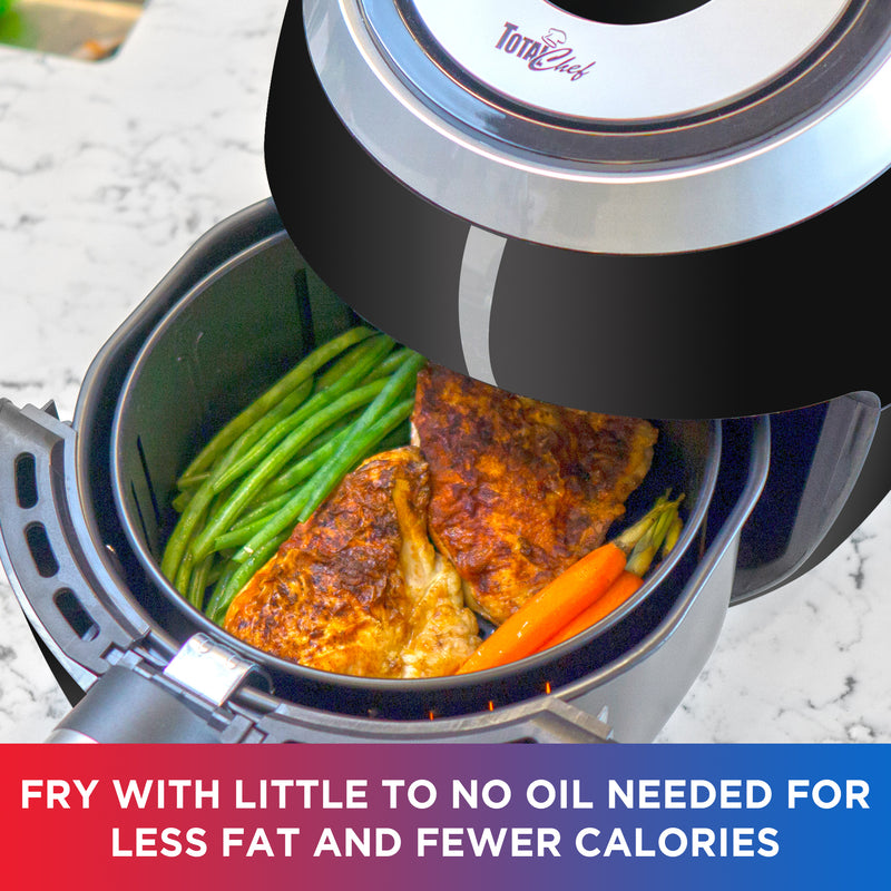 Lifestyle image of Total Chef air fryer viewed from above on a white marble counter with the cooking basket partly pulled out and filled with green beans, chicken thighs, and carrots. Text below reads, "Little to no oil needed for less fat and fewer calories"
