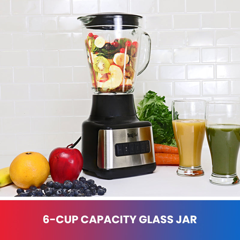 Lifestyle image of blender with fruit in and around blender and glasses of orange and green smoothie beside on white kitchen counter. Text below reads "6-cup capacity glass jar"