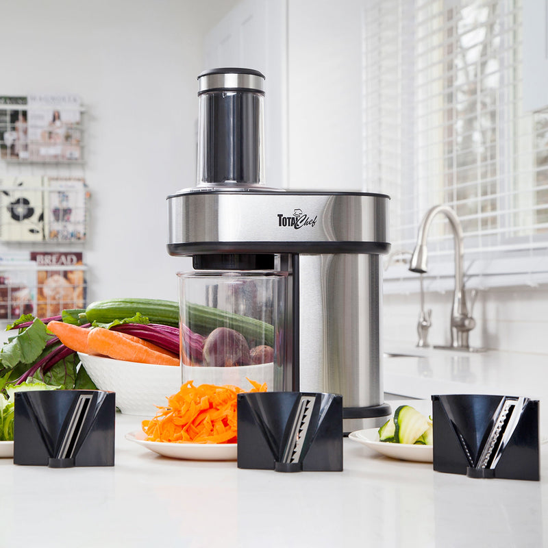 Lifestyle image of spiralizer on a white counter with 3 blades and small plates of spiralized vegetables in front