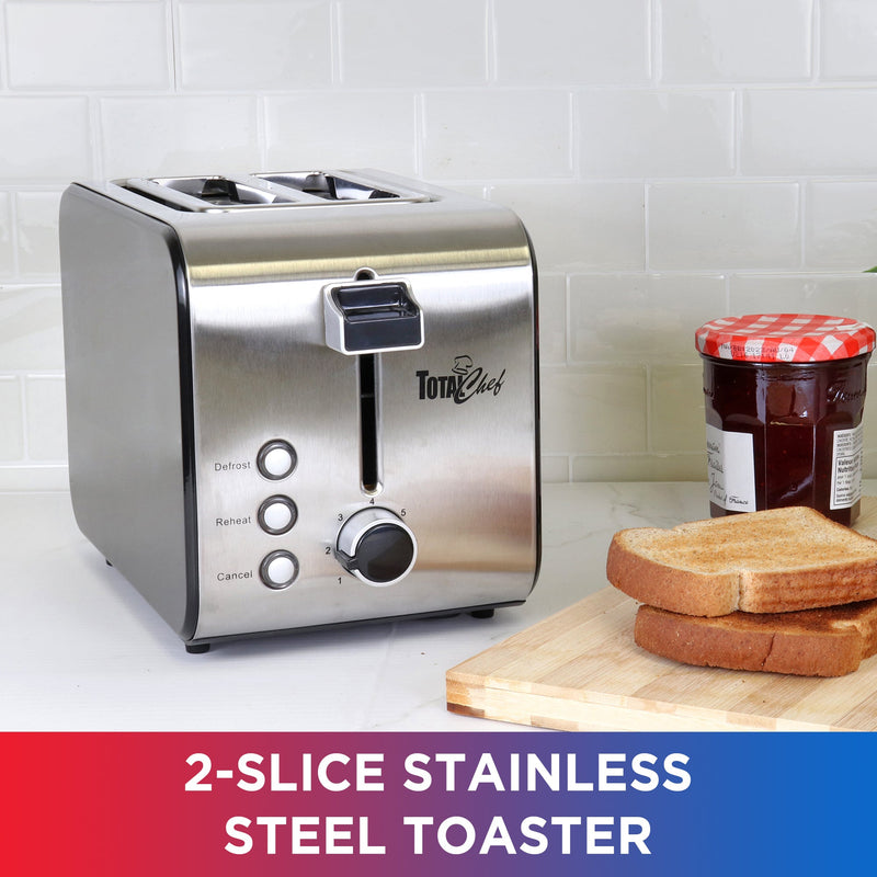 Lifestyle image of toaster beside a cutting board with two slices of toast and a jar of jam to the right on a white countertop with white backsplash. Text below reads, "2-slice stainless steel toaster"