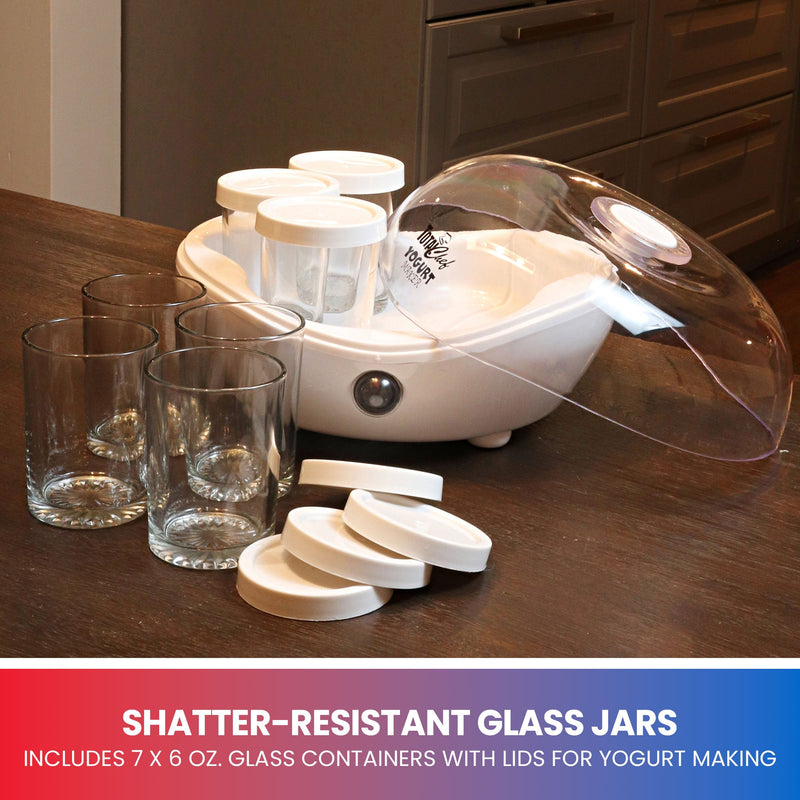 Lifestyle image of yogurt maker, jars, and lids on dark wooden table. Text below reads, "Shatter-resistant glass jars: Includes 7 x 6 oz. glass containers with lids for yogurt making"