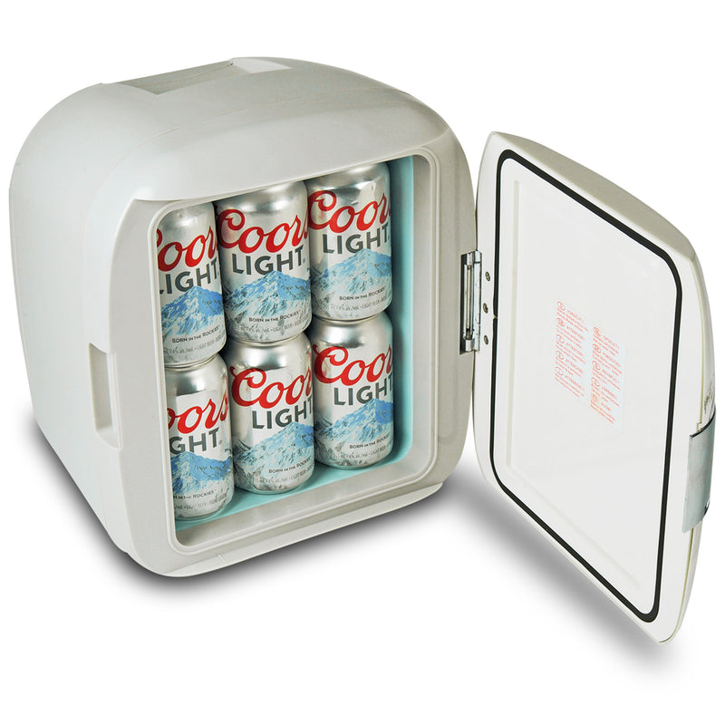 Lifestyle image of Coors Light 12 can cooler/warmer, closed, on brown side table with two cans of Coors Light beer to the left and a white vase behind it